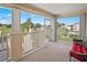 Balcony with stunning views and a comfy red chair at 26283 Nadir Rd # 201, Punta Gorda, FL 33983