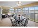 Bright sunroom with lake view, table, chairs, and comfortable seating at 26283 Nadir Rd # 201, Punta Gorda, FL 33983