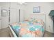 Bedroom with queen-size bed and built-in shelving at 26283 Nadir Rd # 201, Punta Gorda, FL 33983