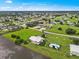 Aerial view showcasing condo, pool, and lake at 26283 Nadir Rd # 201, Punta Gorda, FL 33983