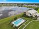 Aerial view showing condo community near lake with pool at 26283 Nadir Rd # 201, Punta Gorda, FL 33983