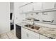 Kitchen boasts granite countertops and double stainless steel sink at 26283 Nadir Rd # 201, Punta Gorda, FL 33983