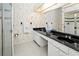 Bathroom with double vanity and black marble countertop at 26283 Nadir Rd # 201, Punta Gorda, FL 33983