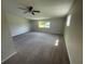 Large bedroom with wall-to-wall carpeting and a ceiling fan at 240 Cicero Nw St, Port Charlotte, FL 33948