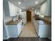 Updated kitchen with white cabinets and tile flooring at 240 Cicero Nw St, Port Charlotte, FL 33948