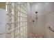 Walk-in shower with glass block wall and pebble floor at 3959 San Rocco Ct # 911, Punta Gorda, FL 33950