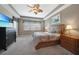 Bright bedroom featuring a large TV and wood furniture at 3959 San Rocco Ct # 911, Punta Gorda, FL 33950