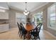 Spacious dining area with a wooden table, black chairs, and large windows at 3959 San Rocco Ct # 911, Punta Gorda, FL 33950