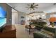 Spacious living room featuring leather sofas, a large TV, and access to the kitchen at 3959 San Rocco Ct # 911, Punta Gorda, FL 33950