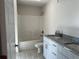 Bathroom with double vanity, granite countertops, and a tub at 10133 Audrey St, Port Charlotte, FL 33981