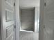 Large walk in shower with gray tile and built in shelving at 10133 Audrey St, Port Charlotte, FL 33981