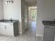 Bright bathroom with dual sinks, granite countertops, and tile flooring at 10133 Audrey St, Port Charlotte, FL 33981