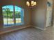 Bright dining room with large arched window and elegant chandelier at 10133 Audrey St, Port Charlotte, FL 33981