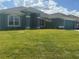 Well-maintained single-Gathering home with a vibrant green lawn at 10133 Audrey St, Port Charlotte, FL 33981