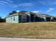 Newly constructed home with gray roof and teal walls, featuring a two-car garage at 10133 Audrey St, Port Charlotte, FL 33981