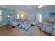Spacious living room with light walls, comfortable seating, and large TV at 729 Macedonia Dr, Punta Gorda, FL 33950