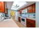 Kitchen boasts wood cabinets, white appliances, and a skylight at 729 Macedonia Dr, Punta Gorda, FL 33950