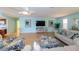 Spacious living area featuring light walls, comfy seating and large TV at 729 Macedonia Dr, Punta Gorda, FL 33950