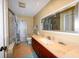 Bathroom with updated vanity, large mirror, and bathtub at 729 Macedonia Dr, Punta Gorda, FL 33950