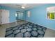 Light and airy bedroom with mirrored closet and ocean-themed rug at 729 Macedonia Dr, Punta Gorda, FL 33950