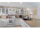 Modern kitchen with white cabinets, granite counters, and breakfast bar at 1355 Hempstead Ave, North Port, FL 34286