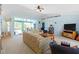 Bright living room with access to the lanai and pool at 1355 Hempstead Ave, North Port, FL 34286