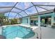 Inviting screened pool area with spacious patio and access to the interior at 1355 Hempstead Ave, North Port, FL 34286
