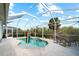 Inviting screened pool with patio and lounge chairs; perfect for relaxation at 3239 Osprey Ln, Port Charlotte, FL 33953