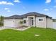 Single-story house with a light-colored stone exterior and a two-car garage at 13454 Ingraham Blvd, Port Charlotte, FL 33981