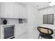 White kitchen cabinets, wine cooler, and espresso machine at 2743 Hopwood Rd, North Port, FL 34287