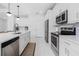 Modern kitchen with white cabinets and stainless steel appliances at 2743 Hopwood Rd, North Port, FL 34287