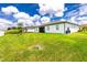 Spacious backyard with a large lawn at 2743 Hopwood Rd, North Port, FL 34287