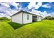 Nice backyard with grassy lawn and home at 2743 Hopwood Rd, North Port, FL 34287