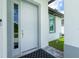 Modern front door with sidelight and gray trim, welcoming entryway at 2743 Hopwood Rd, North Port, FL 34287