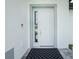 Modern white front door with sidelights and gray trim at 2743 Hopwood Rd, North Port, FL 34287