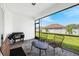 Outdoor kitchen and seating area in a screened patio at 2743 Hopwood Rd, North Port, FL 34287