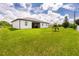 Large backyard with grassy lawn and home at 2743 Hopwood Rd, North Port, FL 34287