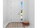 Light and airy entryway with white door and stylish rug at 2743 Hopwood Rd, North Port, FL 34287