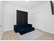 Gathering room with a blue sofa and built in closet at 2743 Hopwood Rd, North Port, FL 34287