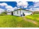 Large backyard with grassy lawn and home at 2743 Hopwood Rd, North Port, FL 34287
