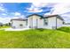 Single story home with white exterior, gray accents, and landscaping at 2743 Hopwood Rd, North Port, FL 34287