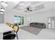 Bright Gathering room with gray sofa, coffered ceiling, and sliding glass doors at 2743 Hopwood Rd, North Port, FL 34287