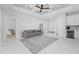 Bright Gathering room with gray sofa and access to other rooms at 2743 Hopwood Rd, North Port, FL 34287