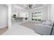 Open living room with kitchen view, gray sofa, and coffered ceiling at 2743 Hopwood Rd, North Port, FL 34287