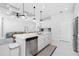 Modern kitchen with white cabinets, island, and stainless steel appliances at 2743 Hopwood Rd, North Port, FL 34287