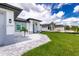 Newly built home with gray siding and paver driveway at 2743 Hopwood Rd, North Port, FL 34287