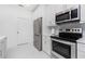 Modern kitchen with white cabinets and stainless steel appliances at 2743 Hopwood Rd, North Port, FL 34287