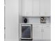 White kitchen cabinets and a built-in wine cooler at 2743 Hopwood Rd, North Port, FL 34287