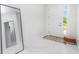 Bright entryway with white walls, marble floor, and full-length mirror at 2743 Hopwood Rd, North Port, FL 34287