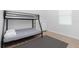 Cozy bedroom with a bunk bed, light wood flooring, and rug at 2743 Hopwood Rd, North Port, FL 34287